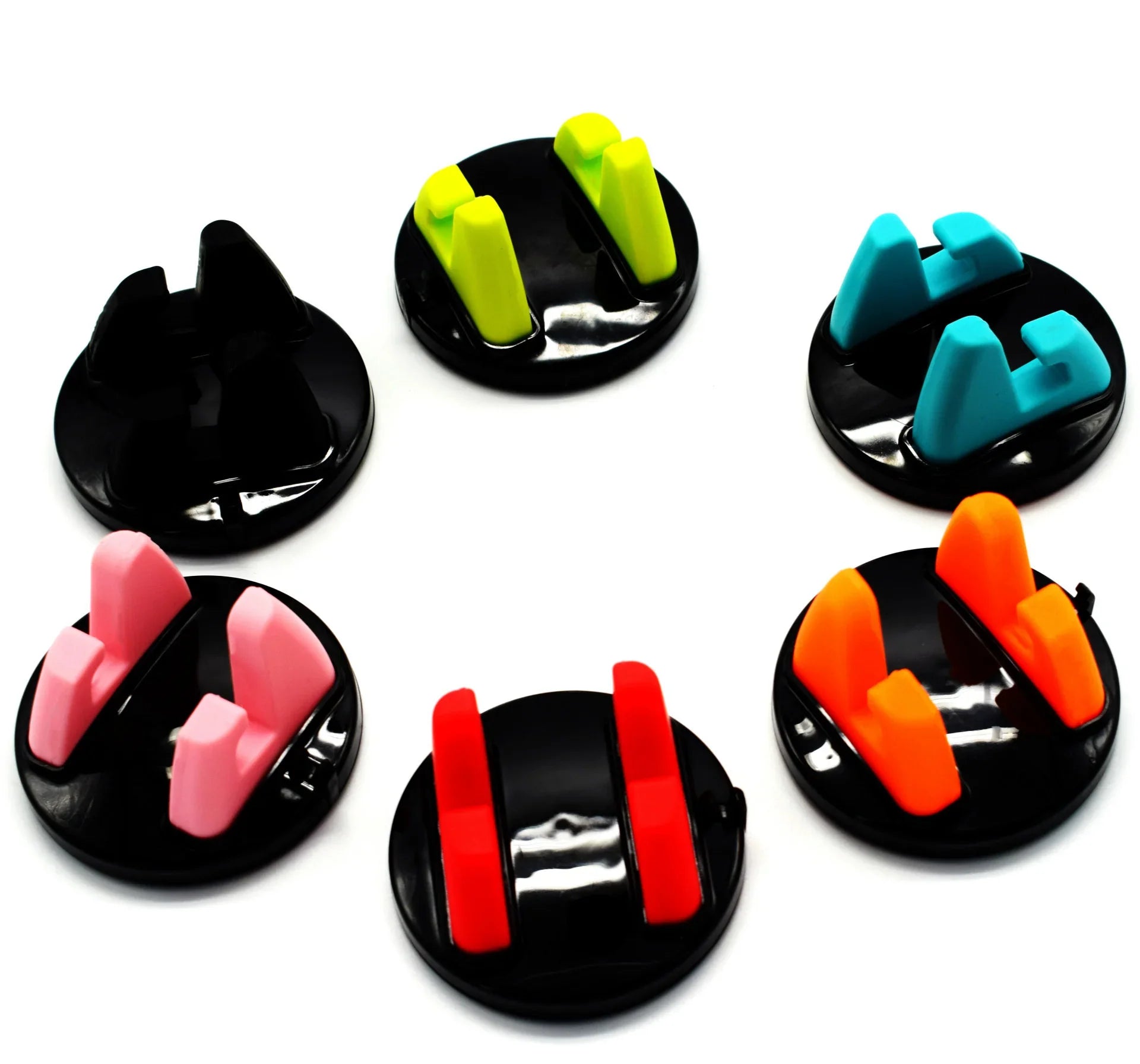 Round cable holders with colorful silicone grips on black bases, organized in a circle on white background.