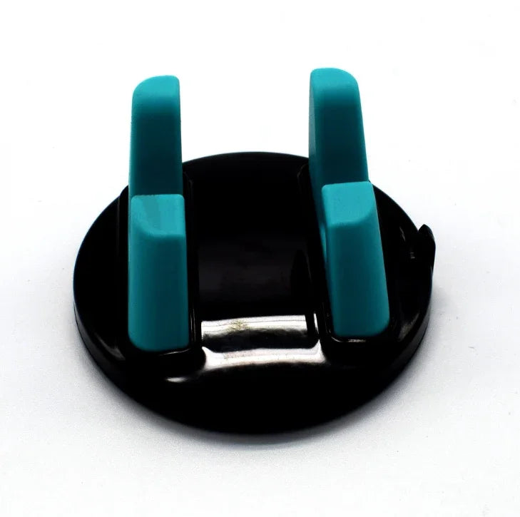 Black round plastic phone holder with two vertical teal grips on white background