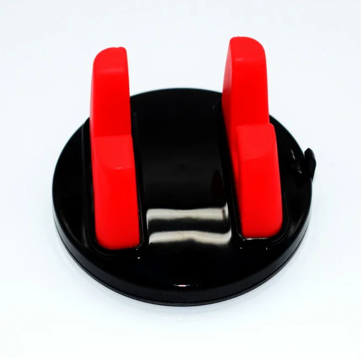 Black and red knife sharpener with dual sharpening slots on white background