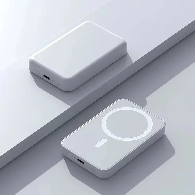 Minimalist white wireless power banks with USB-C ports on a light surface, modern tech accessories.