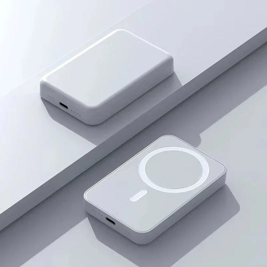 Minimalist white wireless power banks with USB-C ports on a light surface, modern tech accessories.